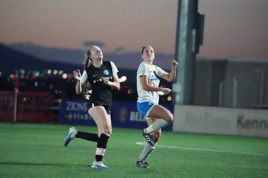 Competing for the ball in the air at the State Cup final.