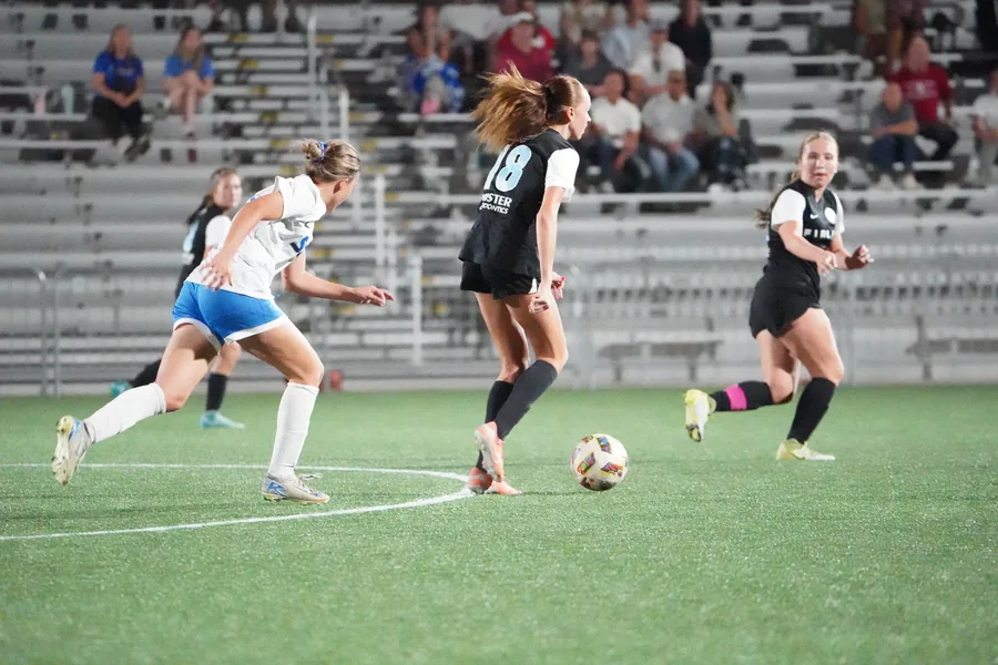 Fire FC controls the ball with teammates in support.