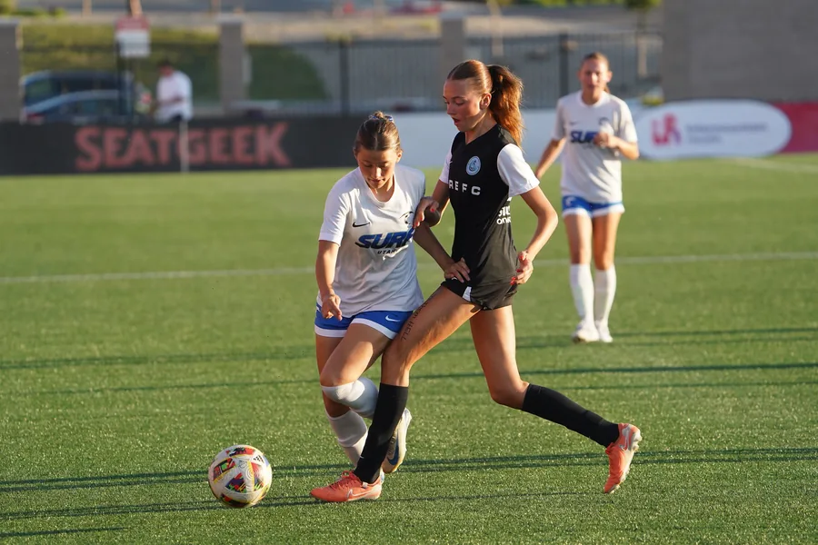 Keeping possession under pressure in the girls' State Cup final.
